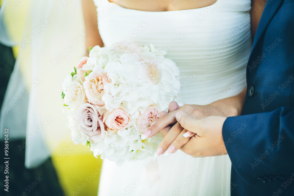 bouquet with pink flowers in hands of the groom and bride bouquet with pink flowers in hands of the groom and bride
