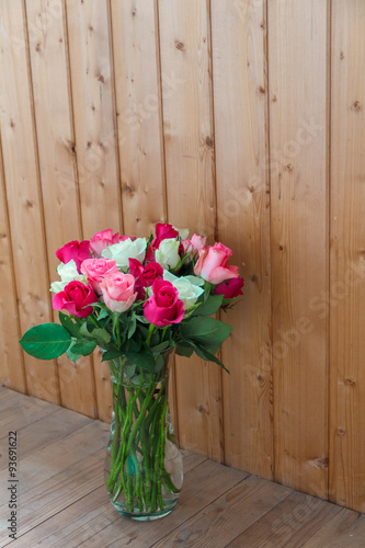 Vase with flowers standing near the window