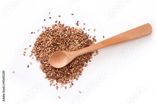 isolated flaxseed and wooden spoon on white background - studio