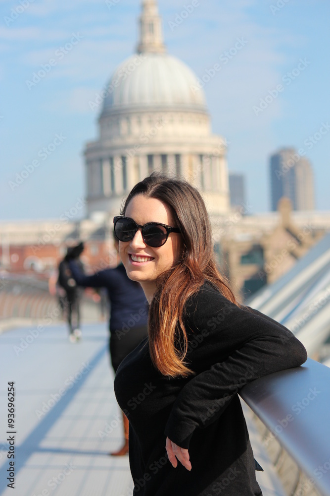 Girl Tourist Smiling in Sunshine with London Skyline Behind.