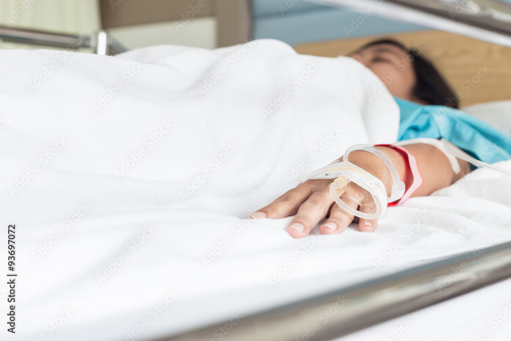 Fototapeta premium Hand of female patient with IV drip needle piercing in hospital