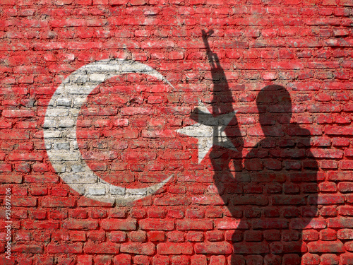 Shadow of man on wall painted with Flag of Turkey photo