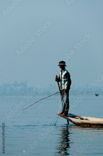 Fisherman at Inle Lake working on one foot