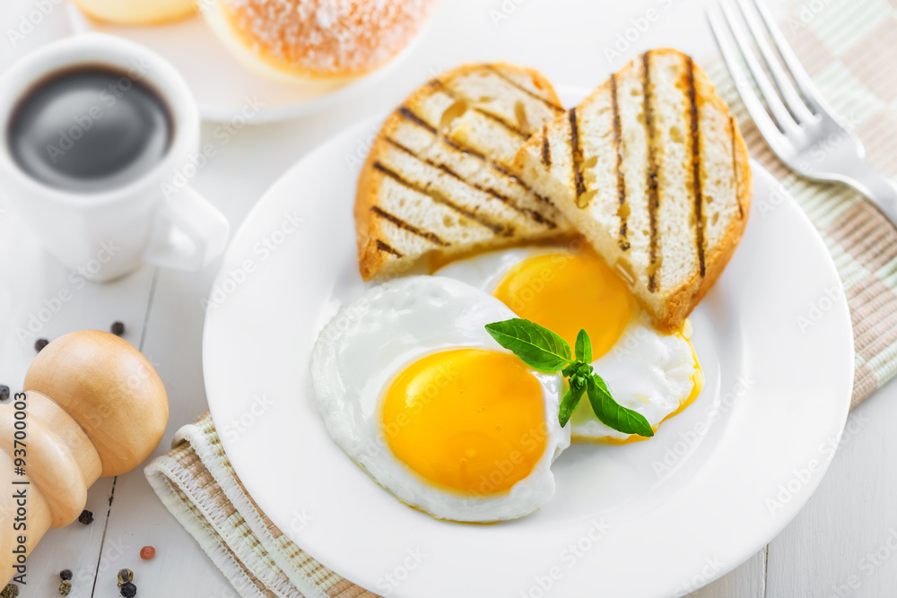 Healthy breakfast on table. Fried eggs with coffee and donuts. Healthy breakfast on table. Fried eggs with coffee and donuts.