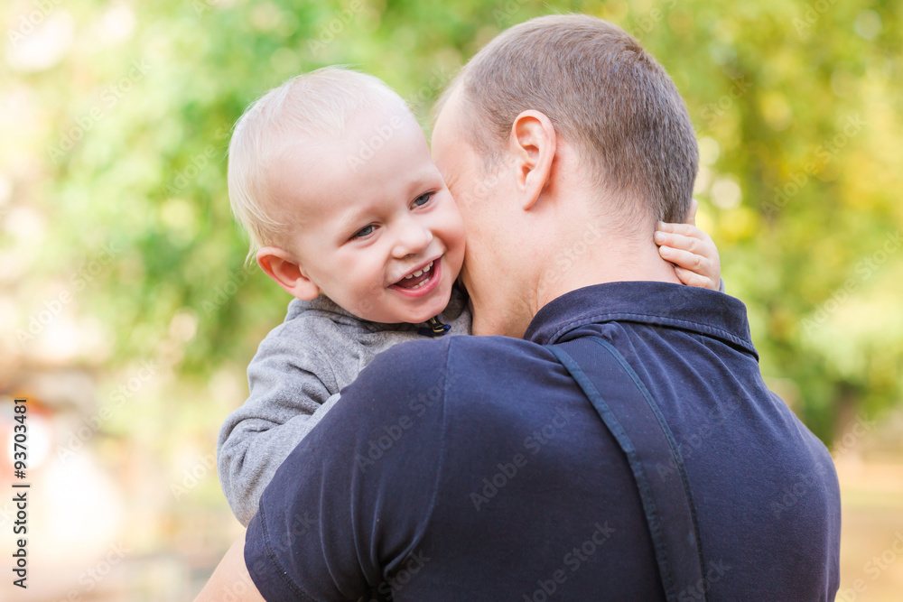 Happy father and his son outdoors. Child hugging daddy. Happy father and his son outdoors. Child hugging daddy.