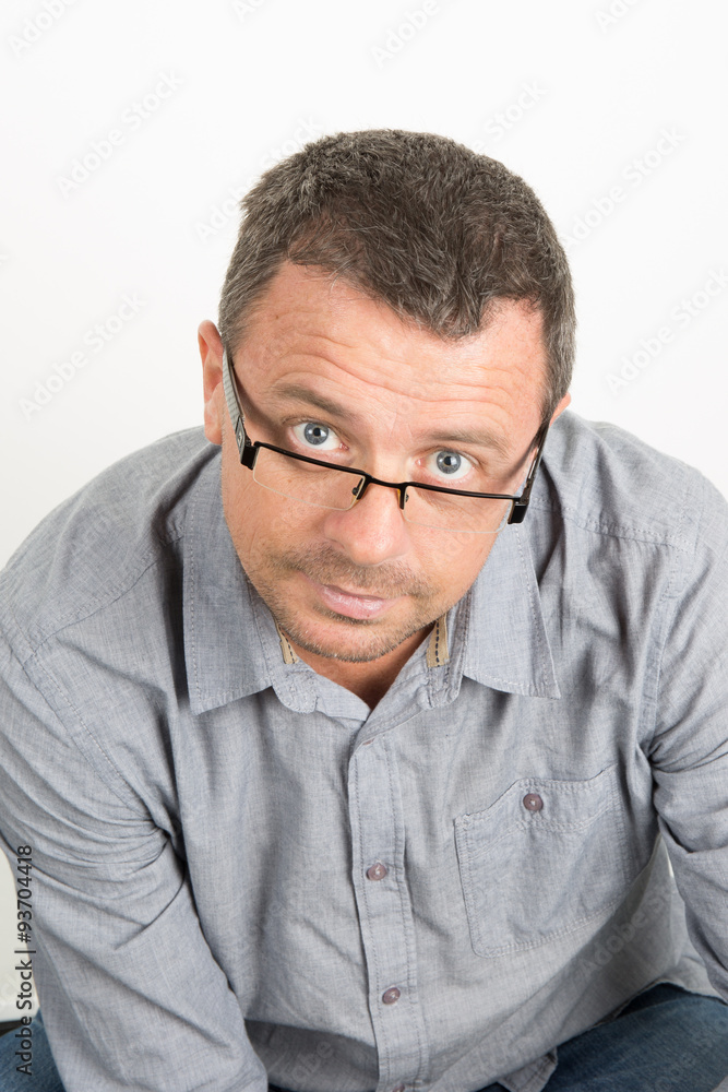Handsome man with glasses, unhaven with a blue casual shirt Handsome man with glasses, unhaven with a blue casual shirt