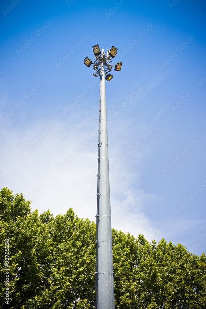 Outdoor train station lights and telecommunication tower against