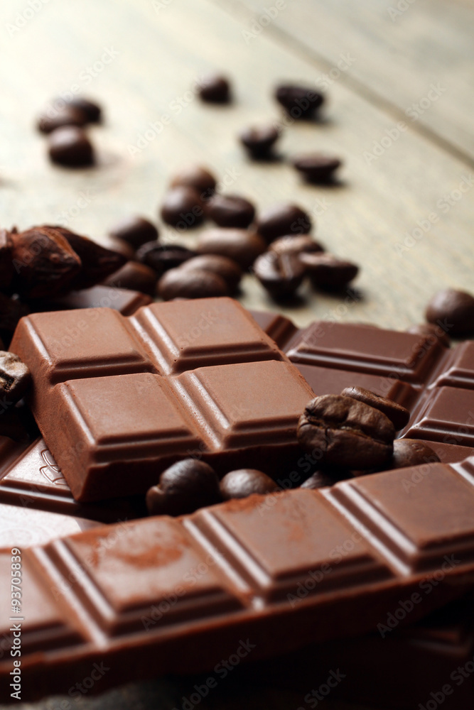 tender milk chocolate and star anise on wooden background tender milk chocolate and star anise on wooden background