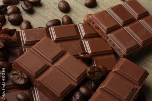 tender milk chocolate and star anise on wooden background