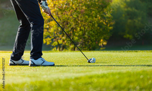 Close-up of man playing golf on green course