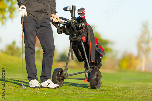 Man playing golf on green course
