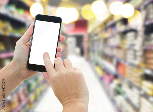 hand holding a modern smartphone in supermarket