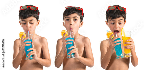 Fotografie Child drinking blue beverage