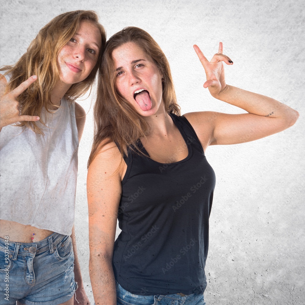 Two friends making horn gesture Two friends making horn gesture