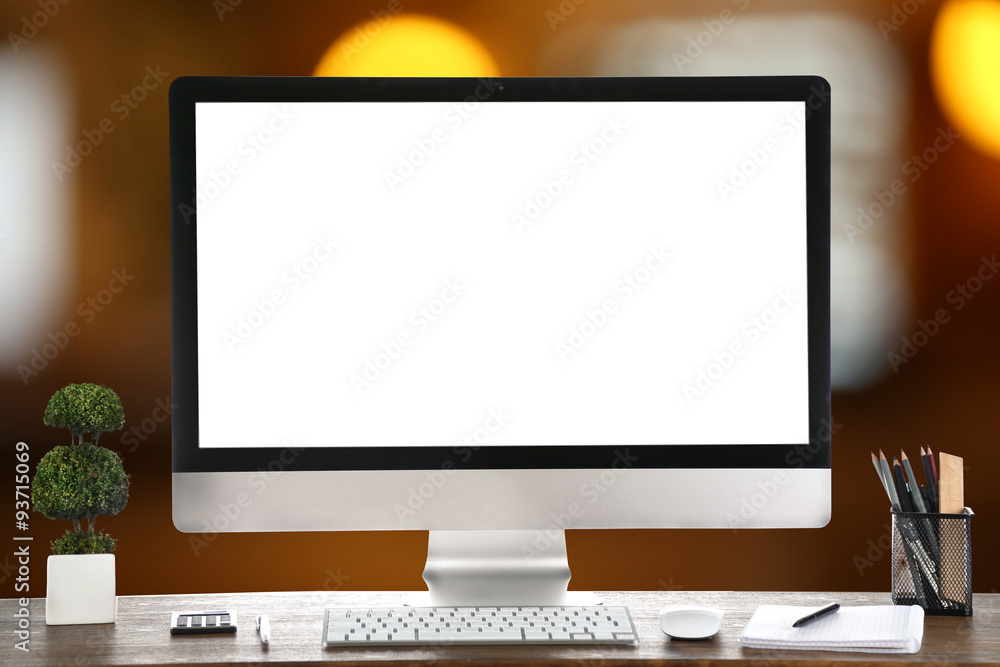 Computer on wooden table on abstract background Computer on wooden table on abstract background