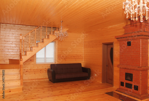 Wooden house interior with stairs and stove