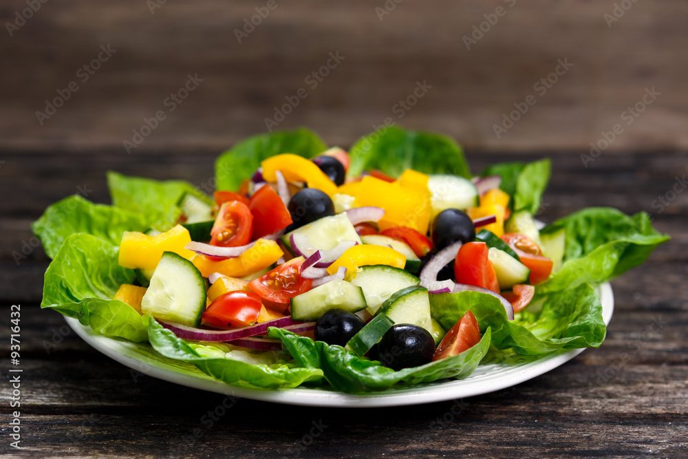 Fresh Vegetable Salad mix, black olives, cherry tomatoes, yellow pepper, red onion, cucumber. On wooden table Fresh Vegetable Salad mix, black olives, cherry tomatoes, yellow pepper, red onion, cucumber. On wooden table