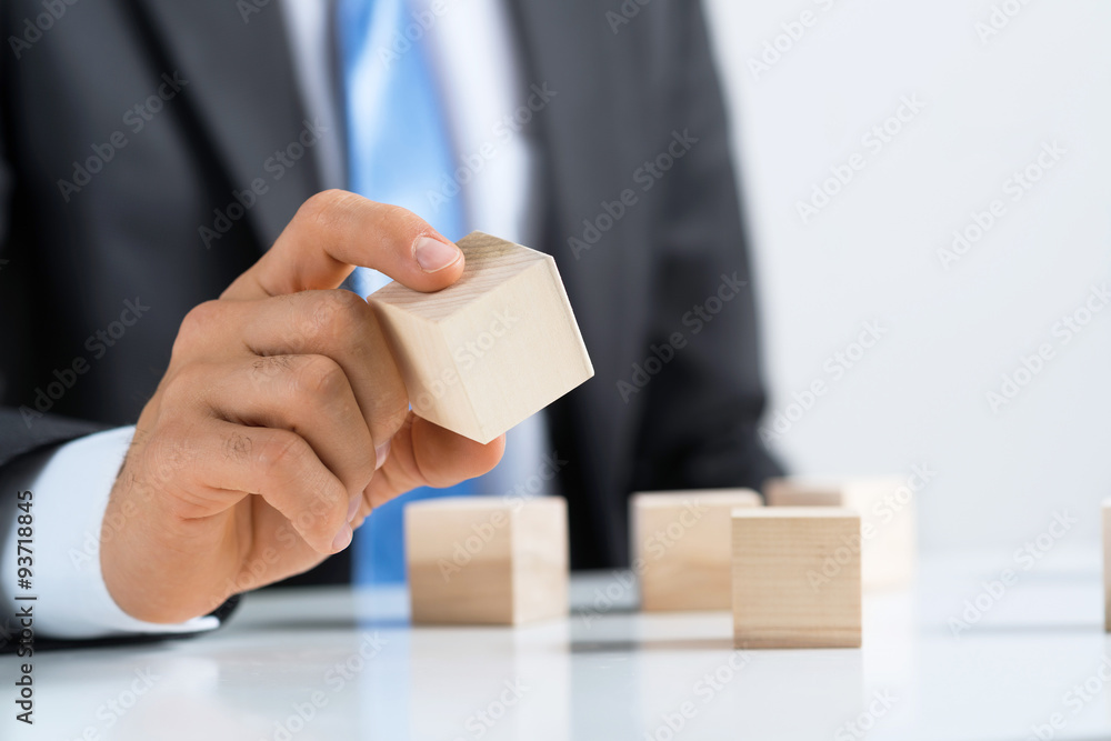 Businessman making tower Businessman making tower