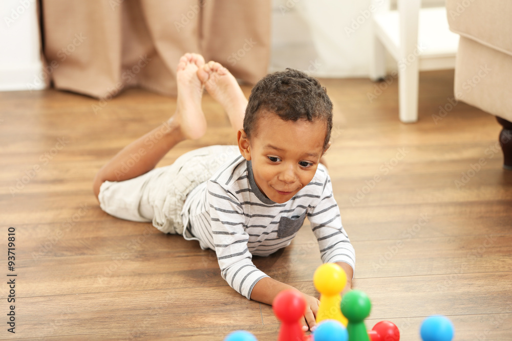Little boy playing bowling in the room Little boy playing bowling in the room