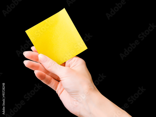 Hand with yellow memo stick...