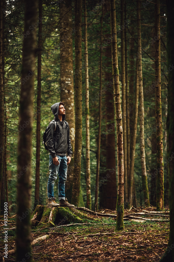 Hooded man posing in the forest Hooded man posing in the forest
