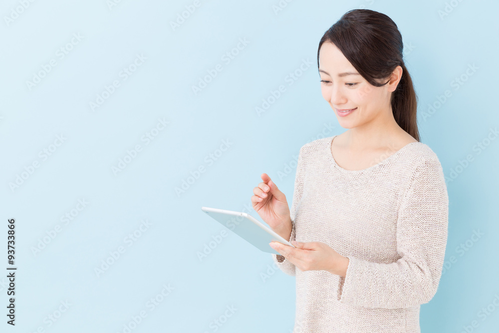 young asian woman using tablet computer young asian woman using tablet computer