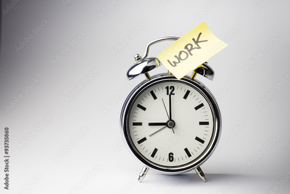 Alarm clock with sticky paper note on white background.. Alarm clock with sticky paper note on white background..
