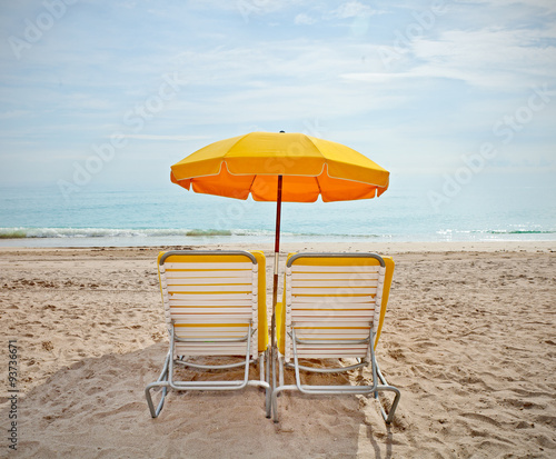 Fototapeta Naklejka Na Ścianę i Meble -  Lounge chairs and colorful umbrellas at the beach in Miami FLorida