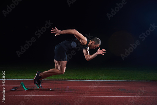 Fototapeta Sprinter leaving starting blocks