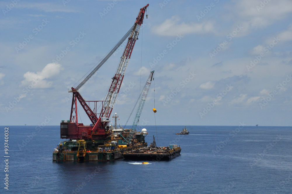crane barge lifting heavy cargo or heavy lift in offshore oil and gas industry. Large boat working for lift piping and installation the platform. crane barge lifting heavy cargo or heavy lift in offshore oil and gas industry. Large boat working for lift piping and installation the platform.
