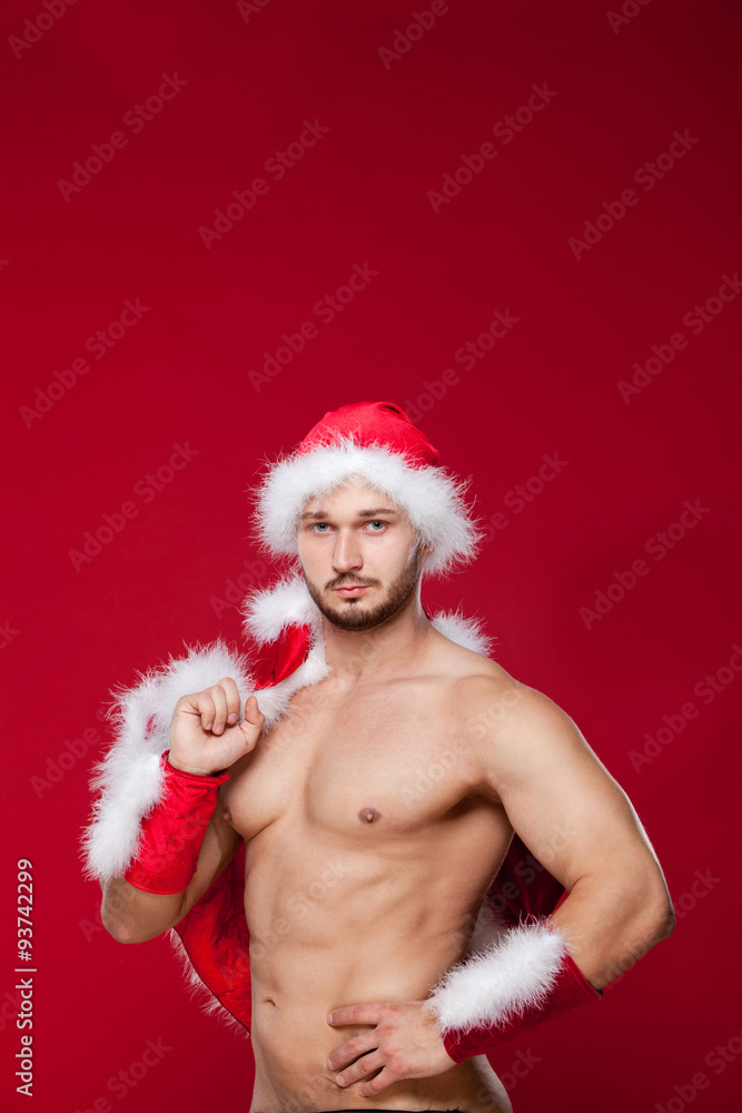 Sexy muscular man in santa uniform. Christmas New Year Sexy muscular man in santa uniform. Christmas New Year