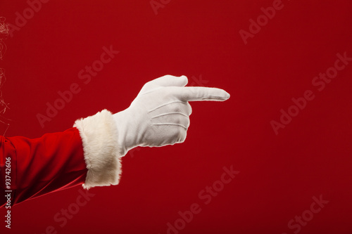 Photo of Santa Claus gloved hand in pointing gesture. fingers photo