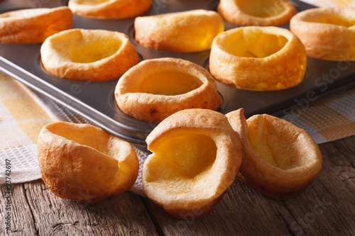 Yorkshire puddings in baking dish close up on the table. horizontal