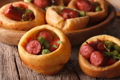 Yorkshire puddings stuffed with sausages close-up. horizontal
 photo