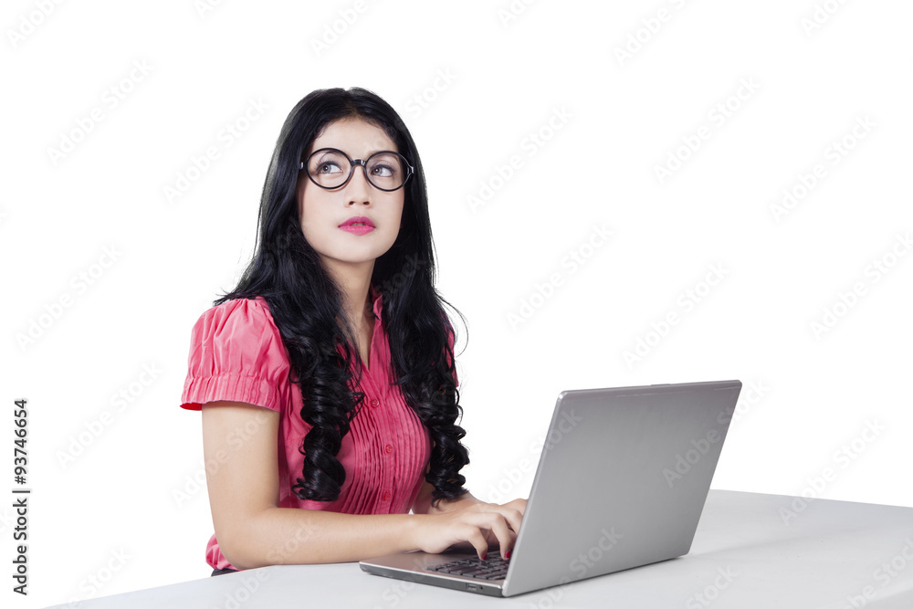 Female worker with laptop and looking at copyspace Female worker with laptop and looking at copyspace