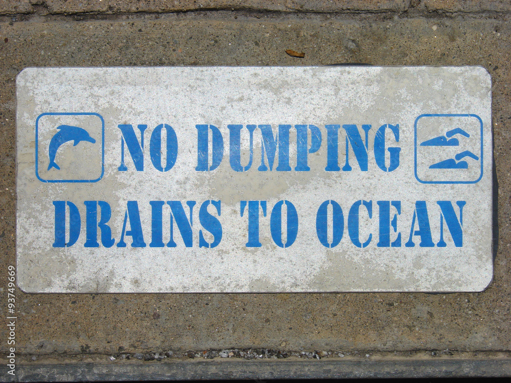 no dumping drains to ocean sign on concrete no dumping drains to ocean sign on concrete