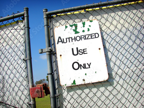 authorized use only sign with locked fence