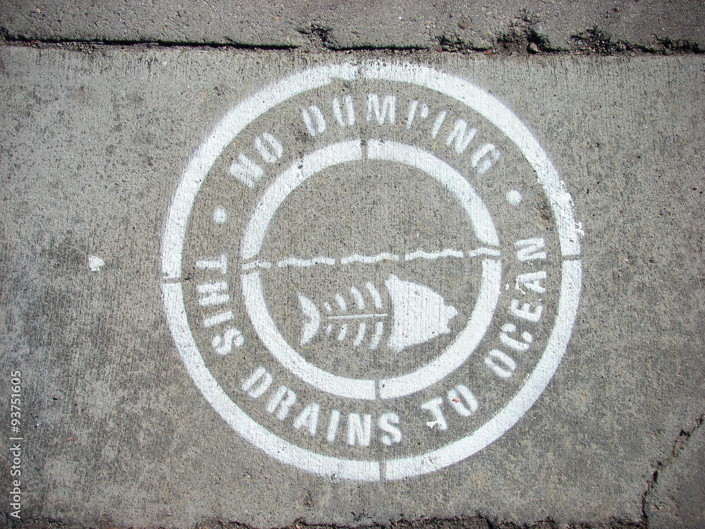 no dumping drains to ocean sign on concrete sidewalk no dumping drains to ocean sign on concrete sidewalk
