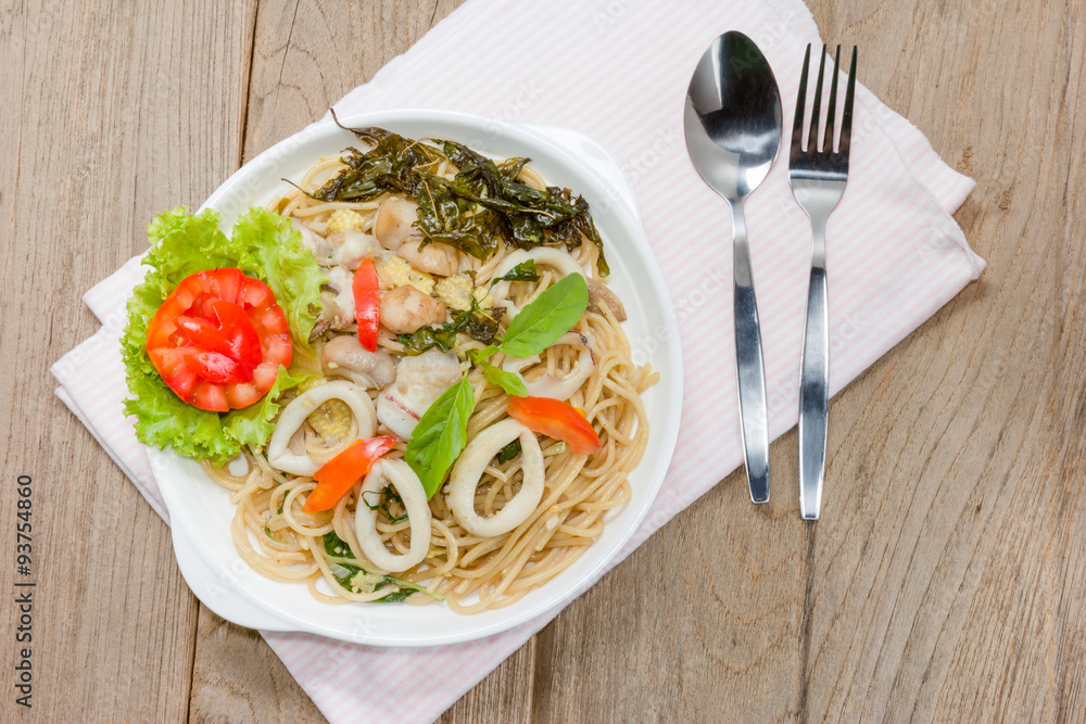 stir fried spaghetti with squid on wood background stir fried spaghetti with squid on wood background