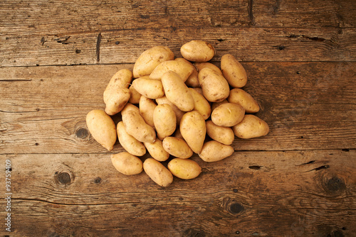 many potato on wooden kitchen table