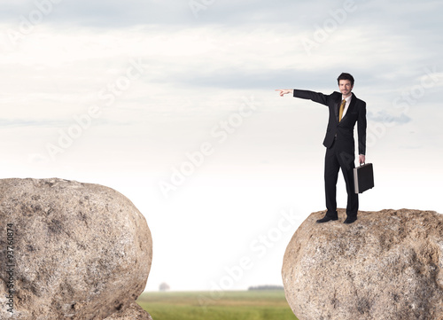 Businessman on rock mountain