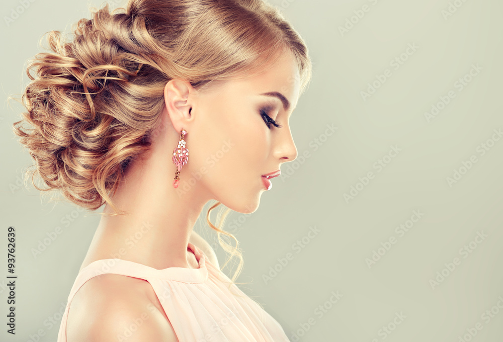 Fototapeta Beautiful model with elegant hairstyle . Beautiful woman with fashion wedding hairstyle and colourful makeup