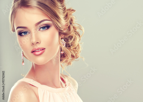 Beautiful model with elegant hairstyle . Beautiful woman with fashion wedding hairstyle and colourful makeup 