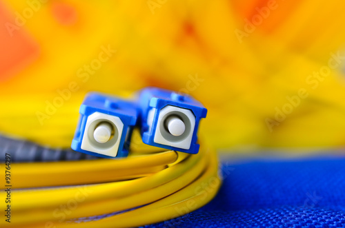 Fiber optic connectors close up on a colourful background. photo