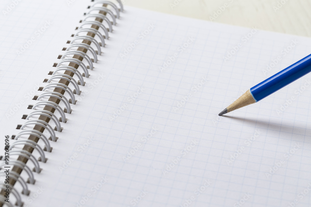 close-up blue pencil on graph paper background close-up blue pencil on graph paper background