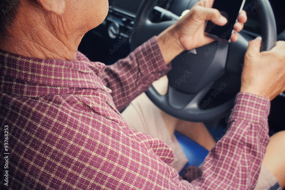Fototapeta premium Man using smart phone in the car.
