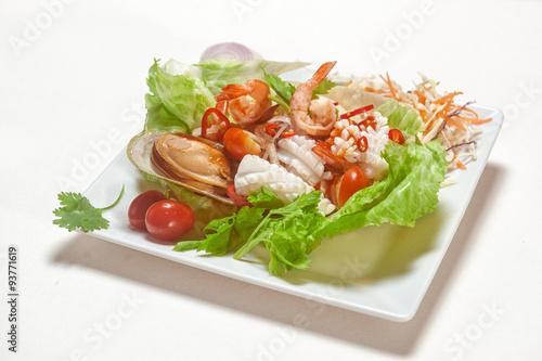 Seafood salad on lettuce with cherry tomatoe and chili pepper