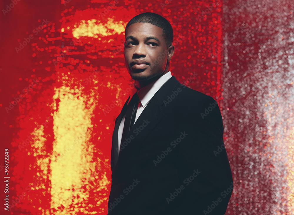 Fototapeta premium Serious retro fifties latin american businessman in front of red