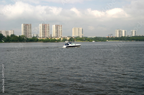 A boat on the river in the residential complex photo