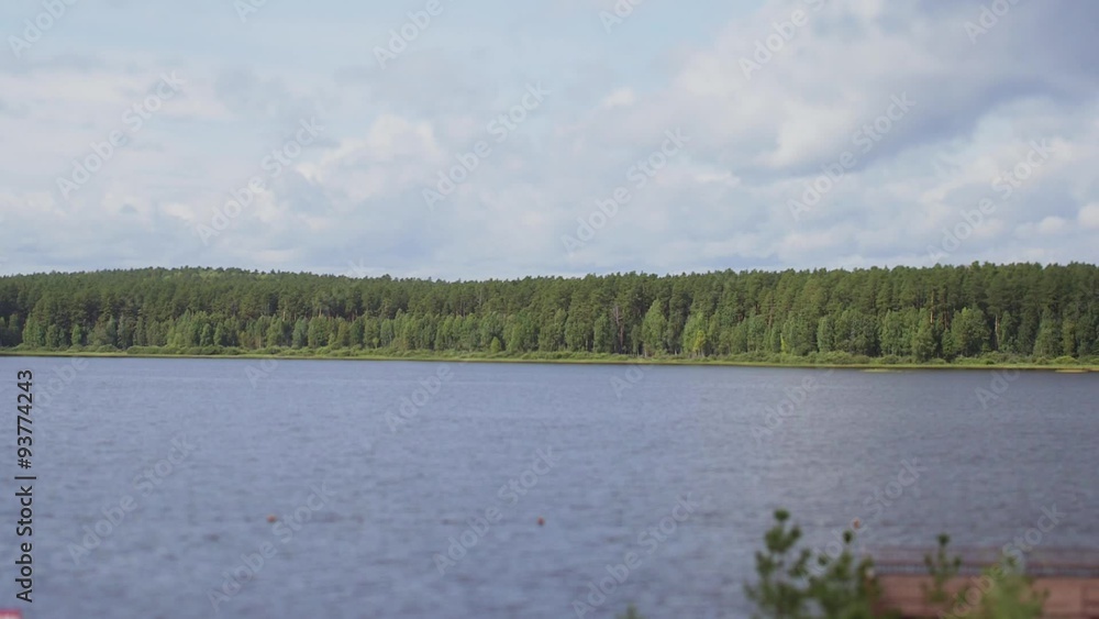 View of wooden pier with trees around, on cloudy sky background View of wooden pier with trees around, on cloudy sky background